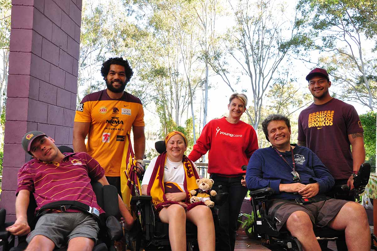 Sam Kennerley with Broncos players Adam Blair and James Gavet, and residents Greig, Hazel and Ryan