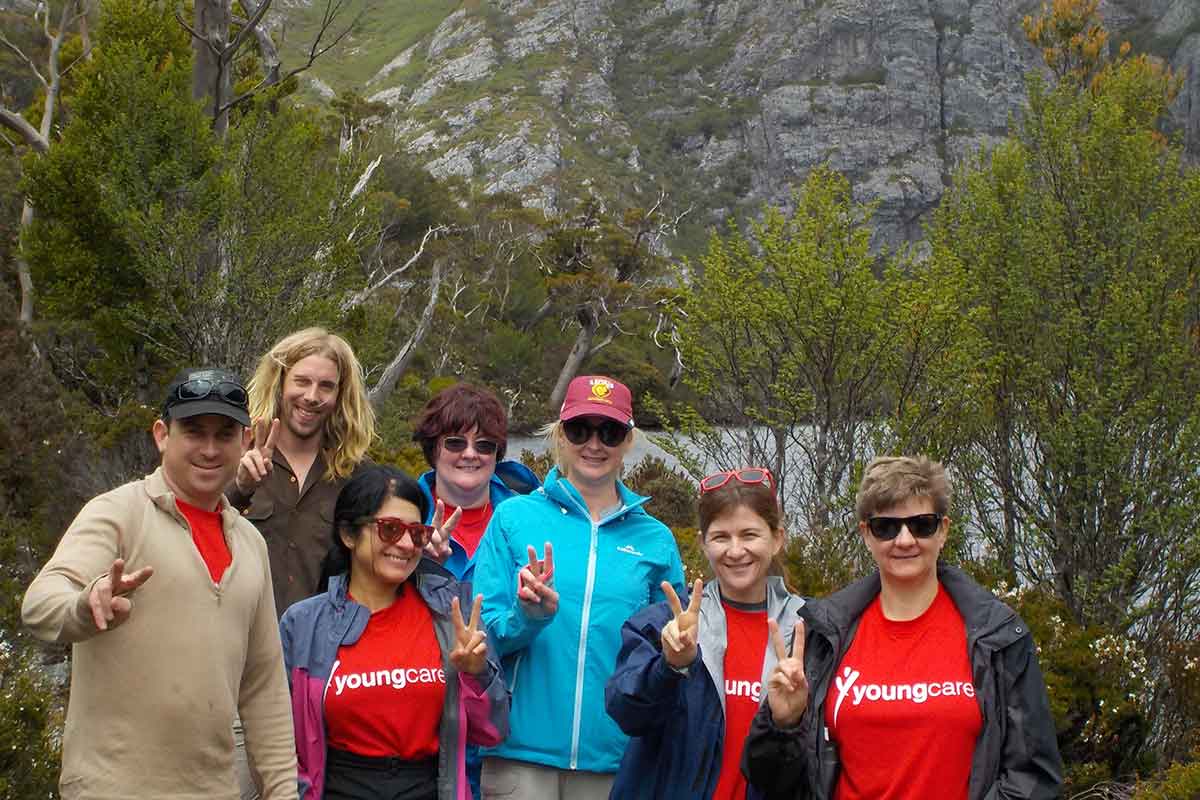 Youngcare-cradle-mountain-trekkers-in-front-of-the-lake-and-trees